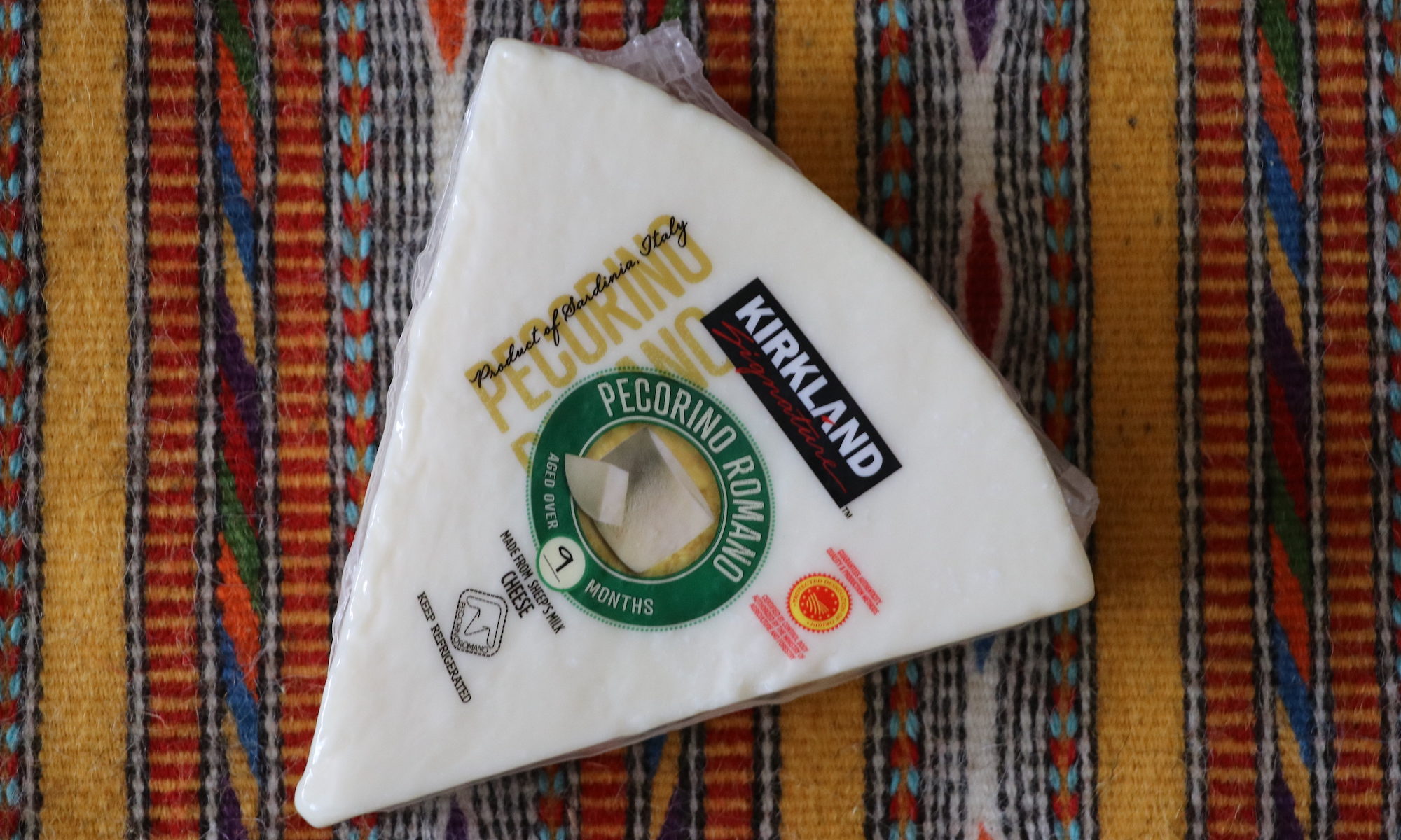 Pecorino Romano, as packaged and sold at Costco. Shown on a handwoven textile from Eugenia Pinna, from Nule, Sardegna.