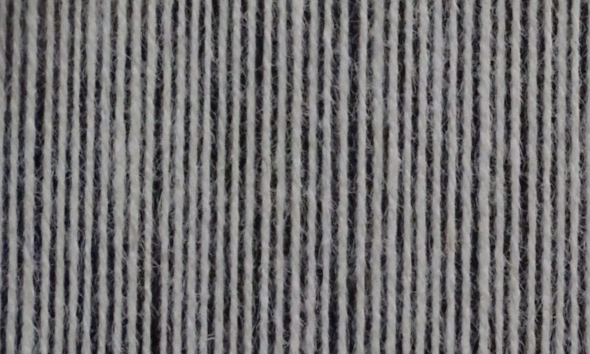 Close up of warp threads on loom.