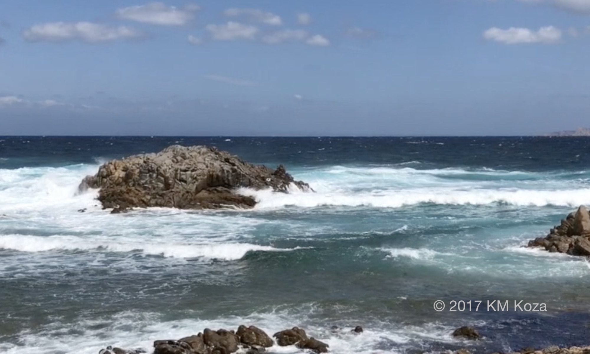 Windy beach with whitecaps in Sardinia.